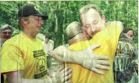 Charles Davidson, right, whose father was killed in Vietnam, is comforted by Terry Whitpan of Wyoming, left and Bill Fowler of Georgia